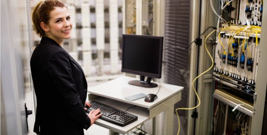 technician-working-on-computer-while-analyzing-server-picture-id653380224